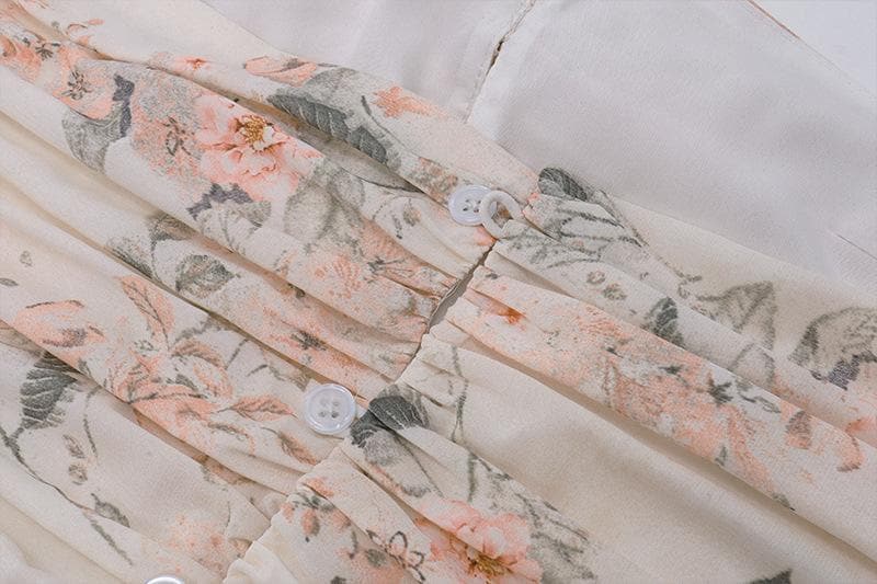 Top corto con schiena scoperta, scollo all'americana, bottoni traforati a contrasto e stampa floreale arricciata
