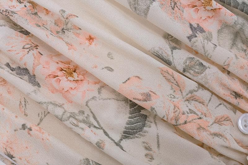 Top corto con schiena scoperta, scollo all'americana, bottoni traforati a contrasto e stampa floreale arricciata