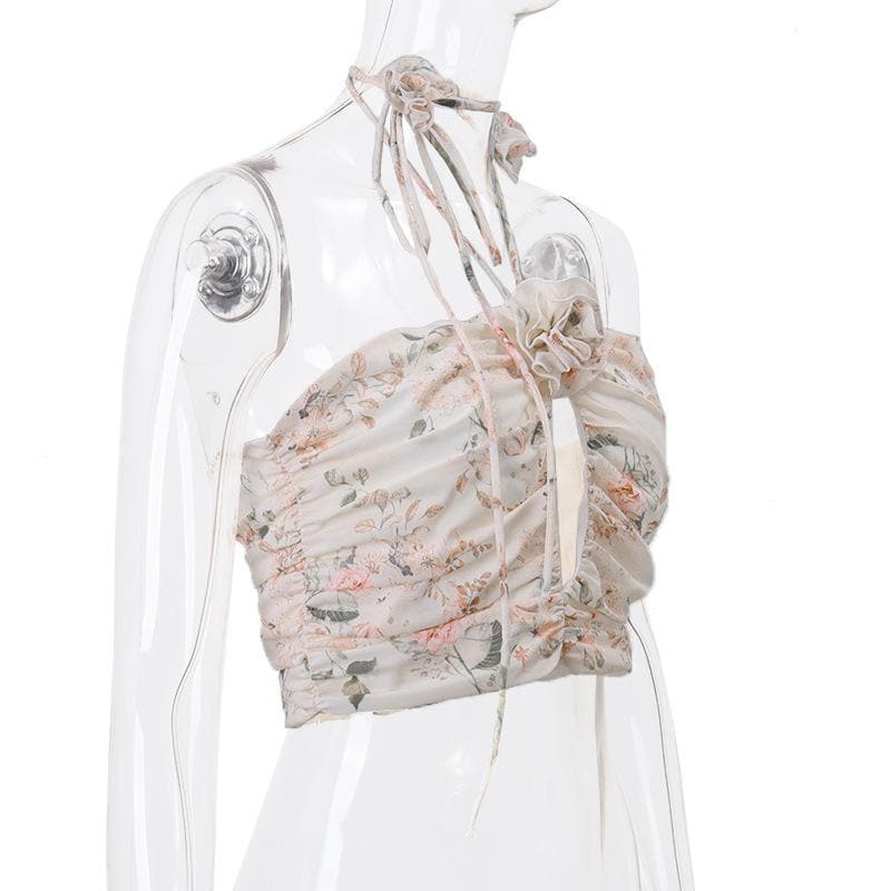 Top corto con schiena scoperta, scollo all'americana, bottoni traforati a contrasto e stampa floreale arricciata