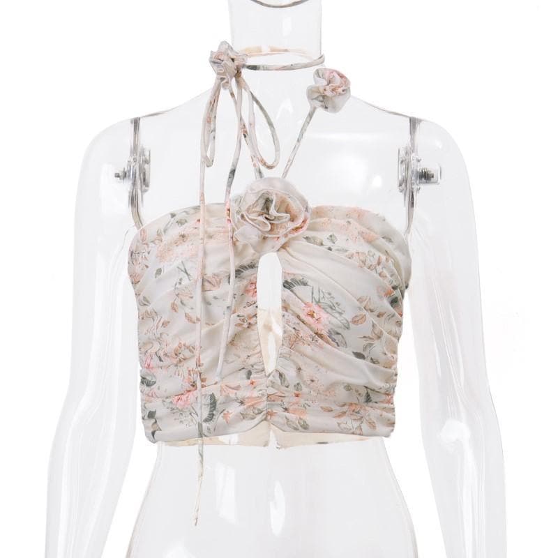 Top corto con schiena scoperta, scollo all'americana, bottoni traforati a contrasto e stampa floreale arricciata