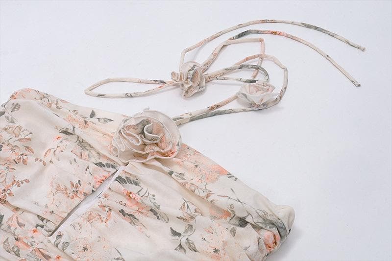 Top corto con schiena scoperta, scollo all'americana, bottoni traforati a contrasto e stampa floreale arricciata