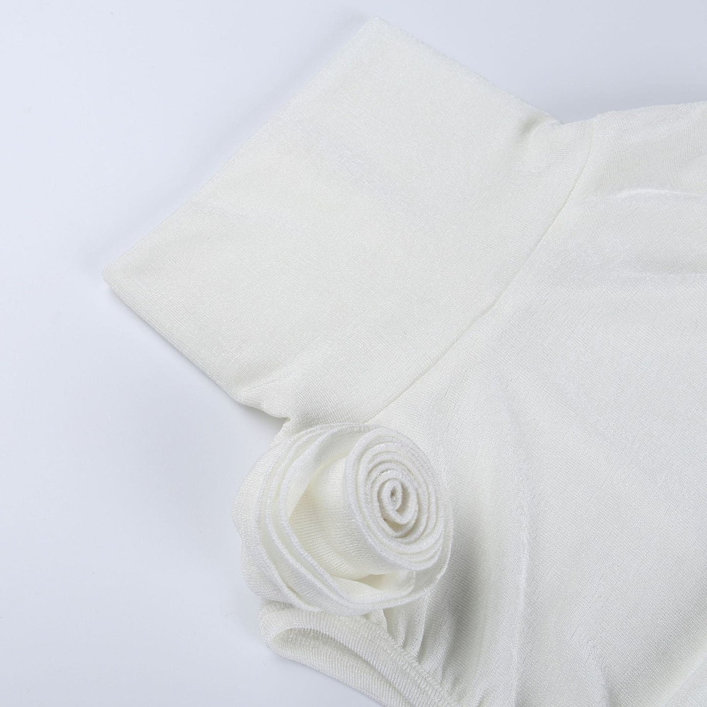 Top senza maniche con scollo a dolcevita e applicazione floreale in tessuto arricciato