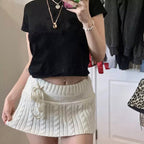 Gonna micro Y2K in maglia a trecce con dettaglio pompon