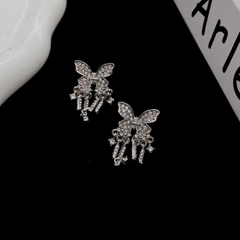 Orecchini con ciondolo a farfalla e nappe in strass 