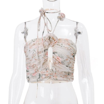 Top corto con schiena scoperta, scollo all'americana, bottoni traforati a contrasto e stampa floreale arricciata 