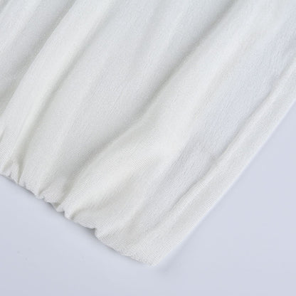 Top senza maniche con scollo a dolcevita e applicazione floreale in tessuto arricciato