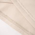 Top a maniche corte con collo alto e perline 