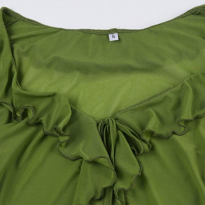 Top in maglia trasparente con volant e maniche svasate e spacchi laterali 